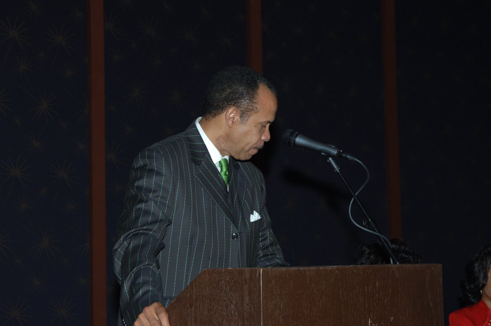 Alumni speaker at podium at formal event
