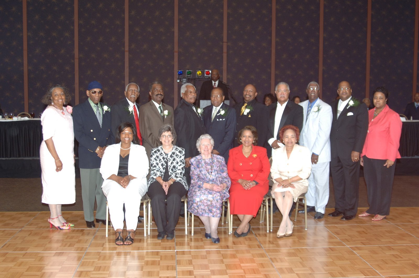 Formal group photo of alumni in elegant attire